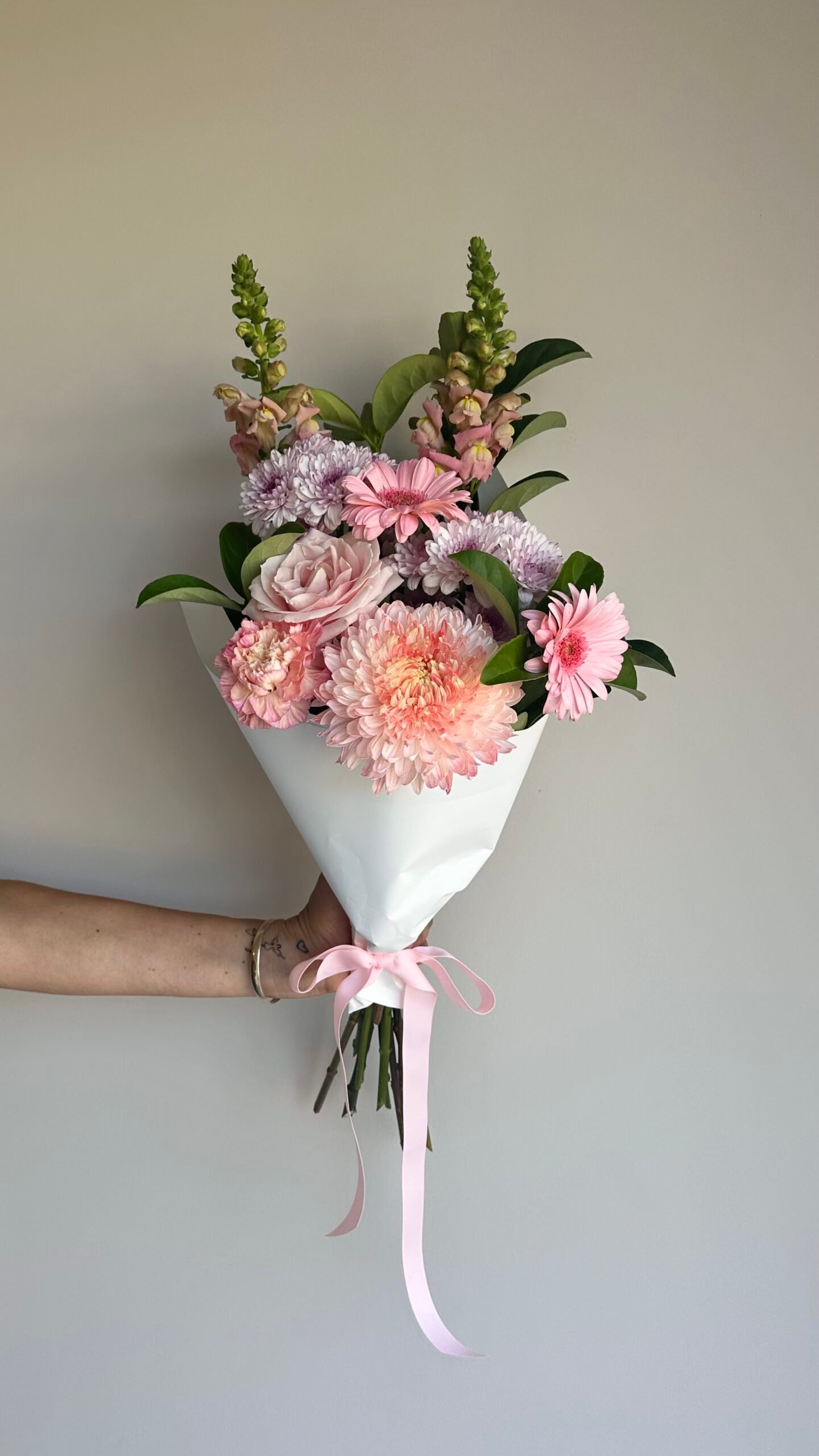 Small Mother’s Day bouquet Gold Coast florist with gerberas, rose, carnations and chrysanthemums wrapped for delivery.